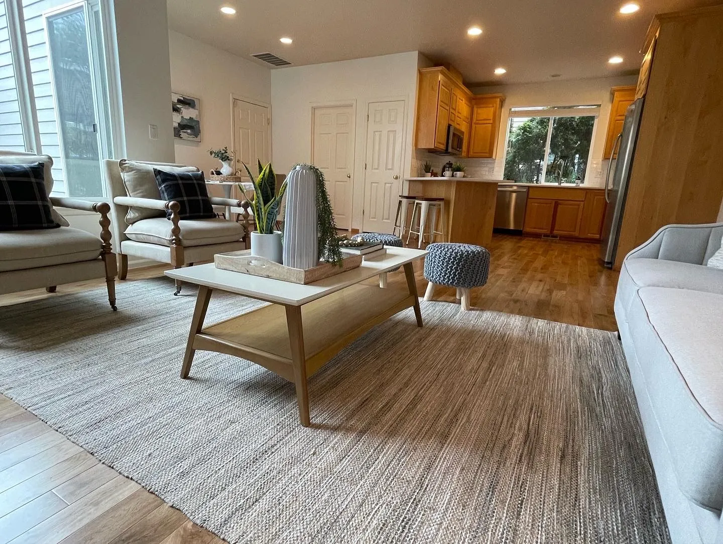 New hardwood floor in a living room open to the kitchen