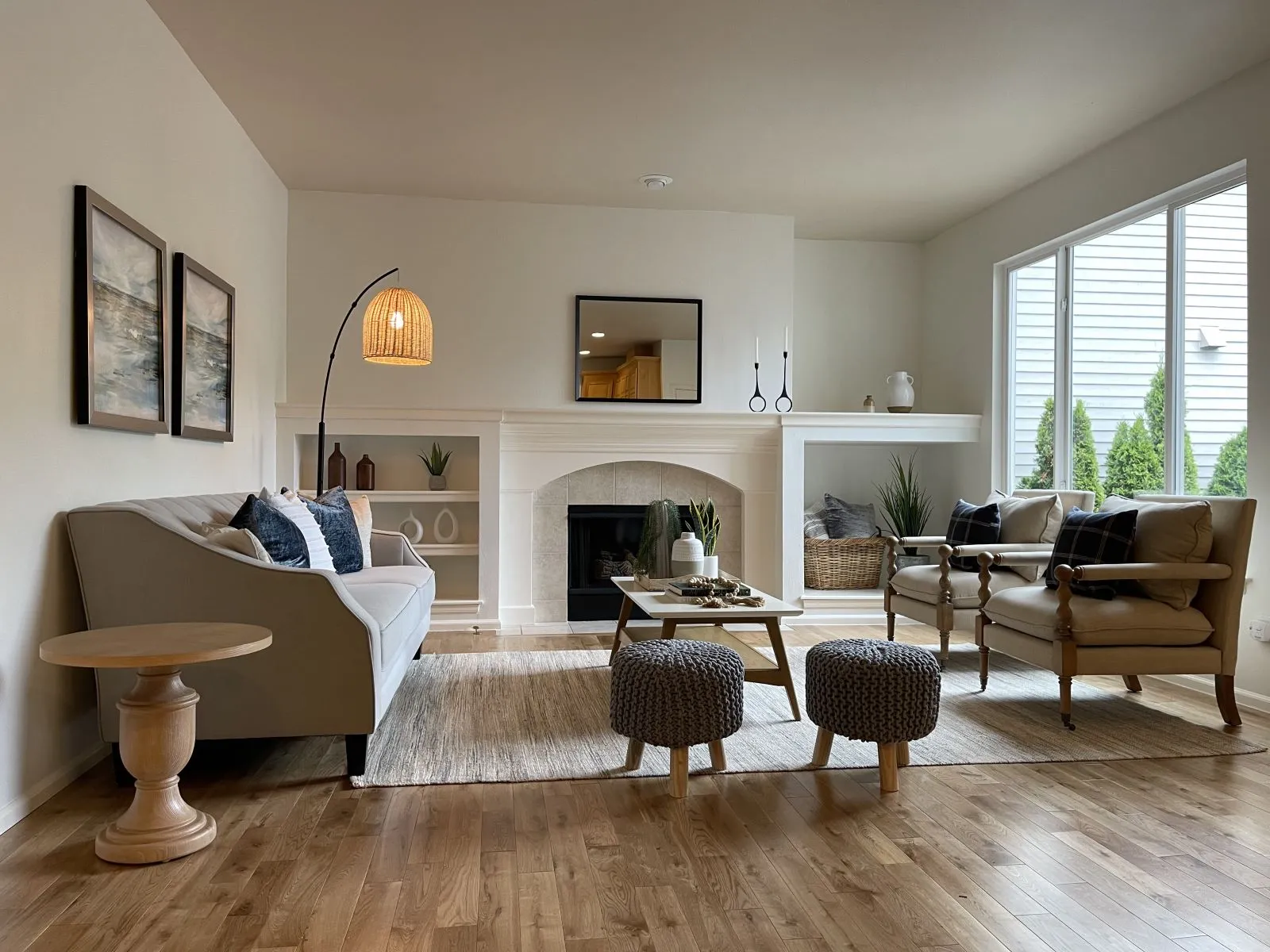 New wide-plank hardwood floor in a living room with a fireplace