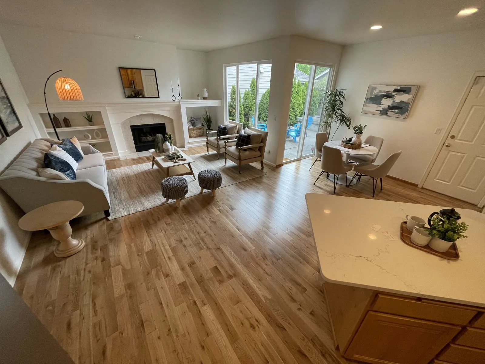 New wide-plank hardwood floor in an open living room and kitchen