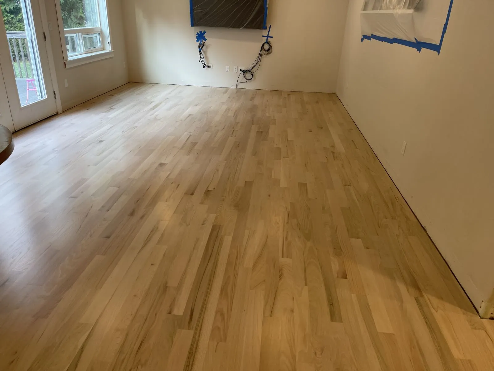 Refinished hardwood floor in an empty room