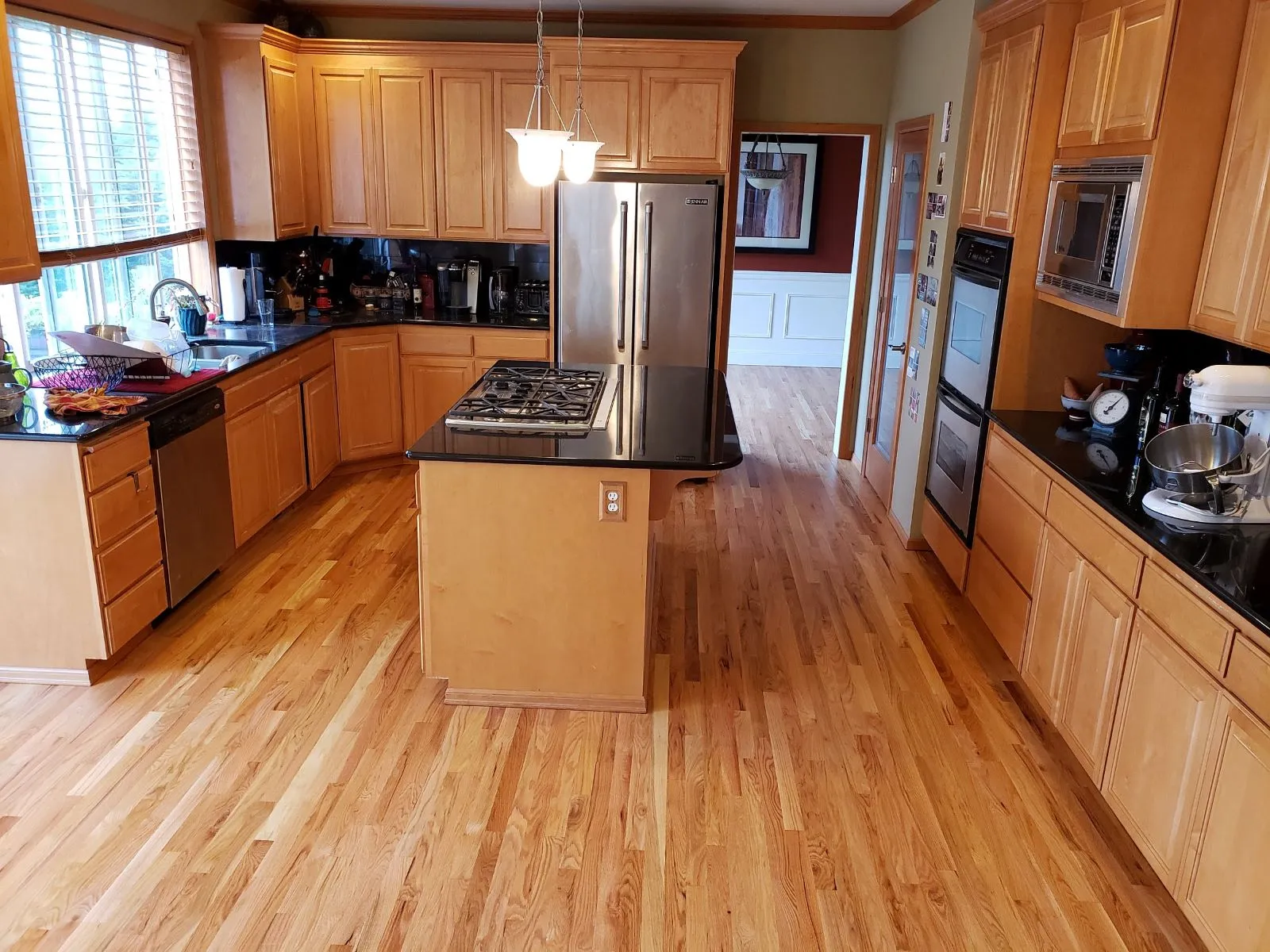 Refinished hardwood floor around a kitchen island