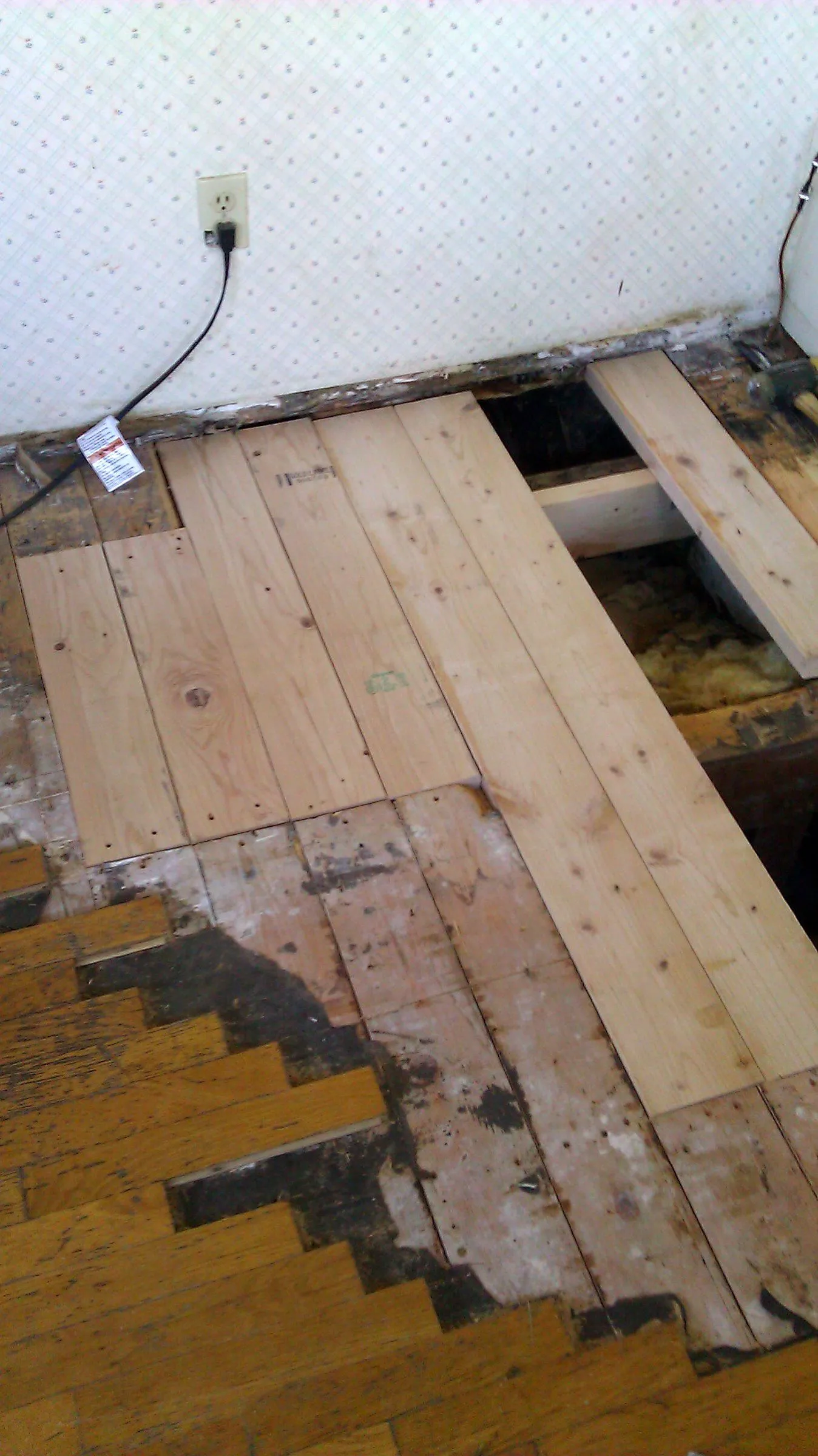 New subfloor boards installed during a floor repair